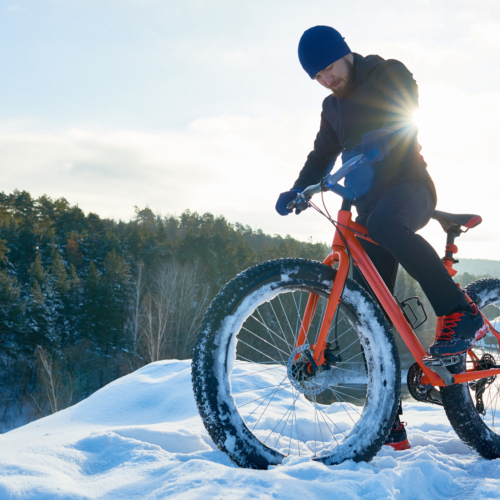 Man travelling by bike in any weather