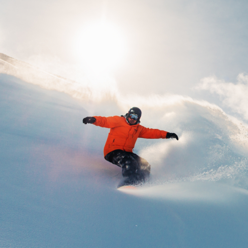 snowboarder is riding from snow hill